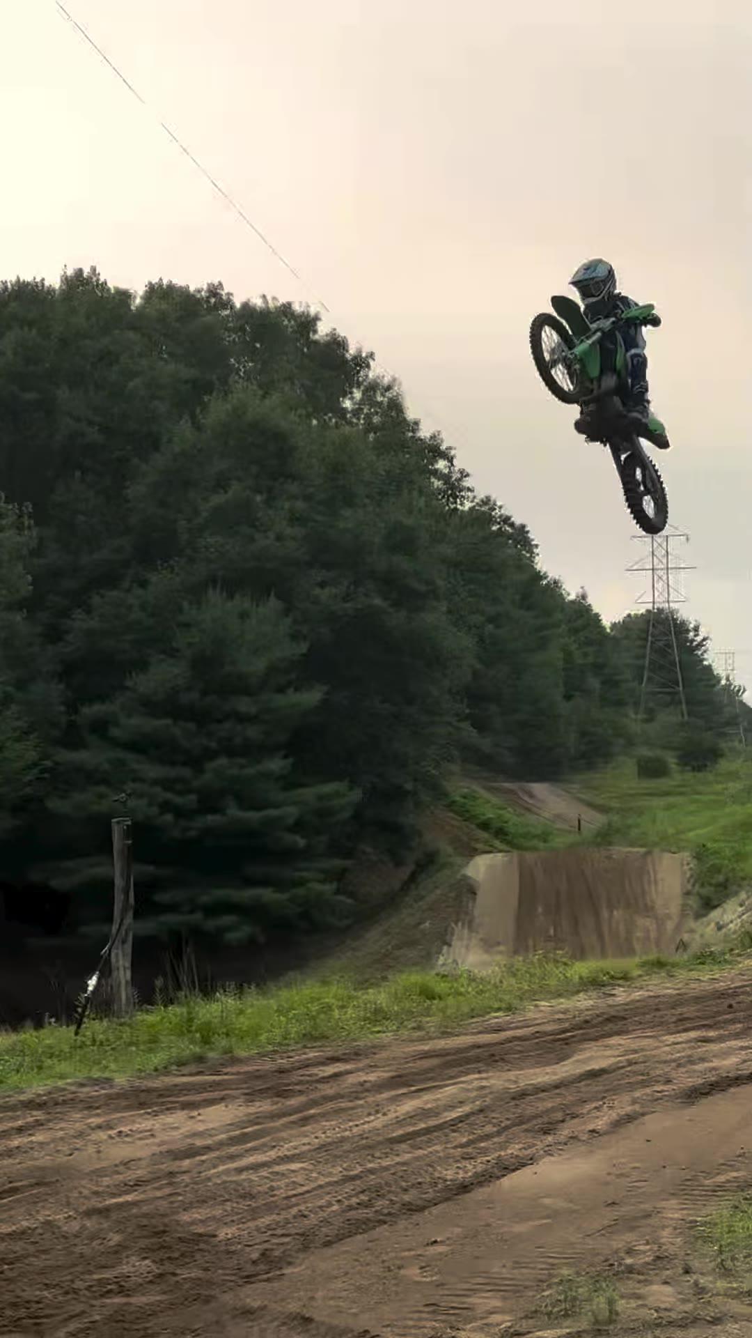 Tucker Aldrich #980 catching air on a motocross track jump